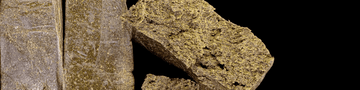 Fine, light-colored hash with a powdery, almost dusty crystalline appearance.