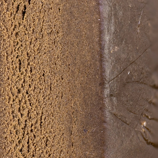 Close-up of Drysift hash showing dense pressed kief structure