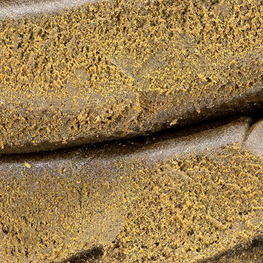 Close-up of Farfar's Favorit THCA hash showing fibrous structure and traditional terpene profile